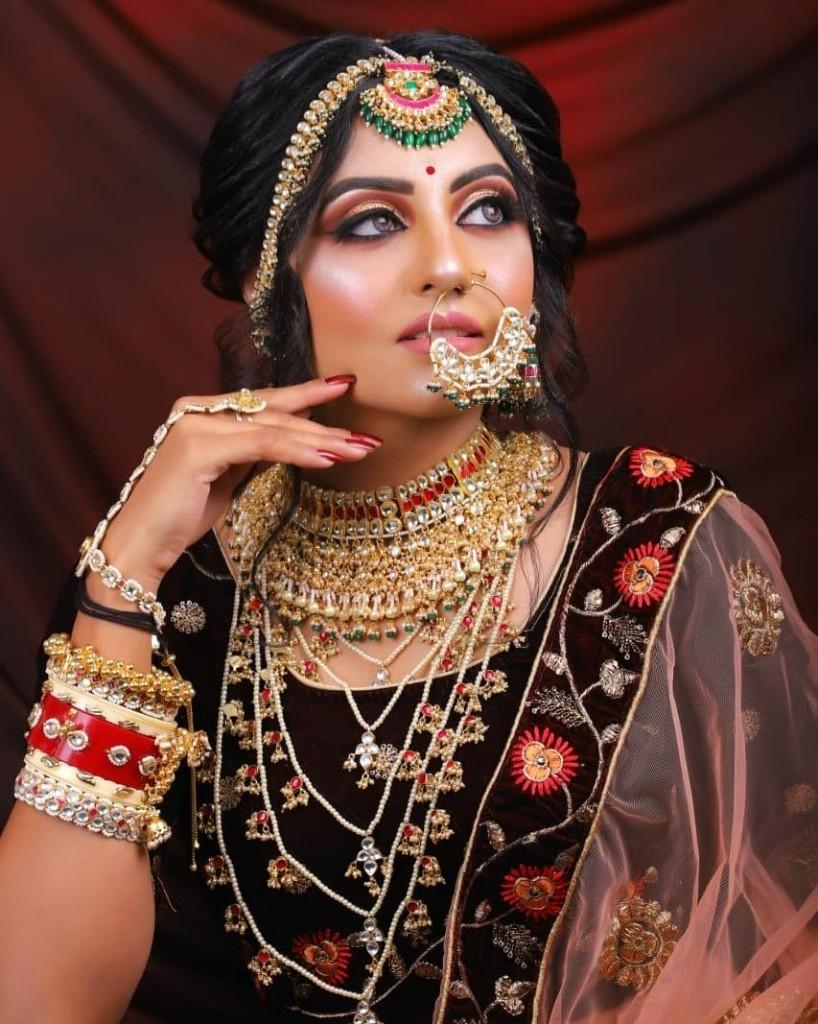 Bridal portrait with detailed eye makeup and statement jewelry by Nensi
