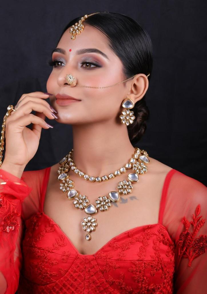 Studio portrait in red outfit with polished glam makeup by Nensi
